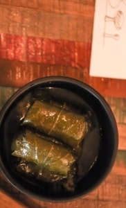 Warm stuffed vine leaves in a modern black claypot